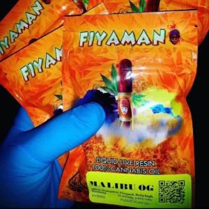 A hand holding a variety of Fiyaman vape cartridges, showcasing different vibrant flavor labels for an array of premium cannabis oil options.